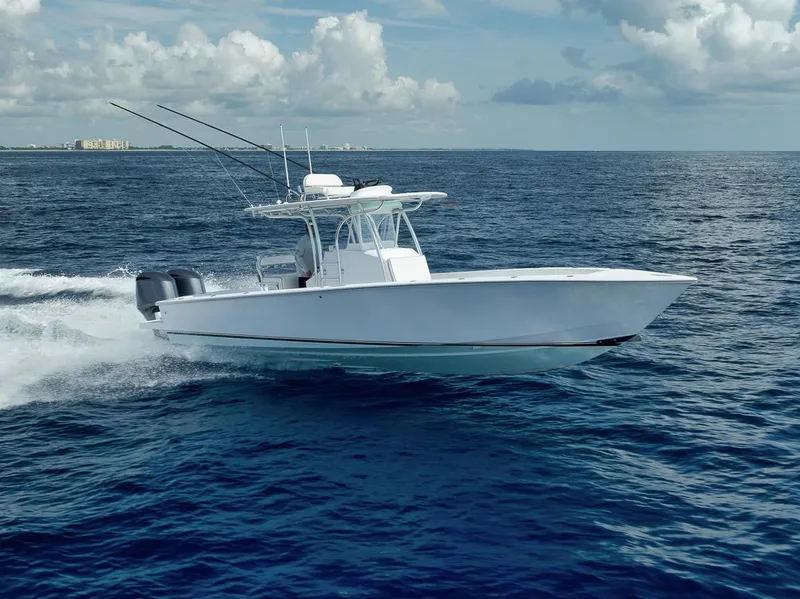 Slide: The Image of 1995 Jupiter 31 Center Console boat cruising on open ocean under cloudy sky. - 0