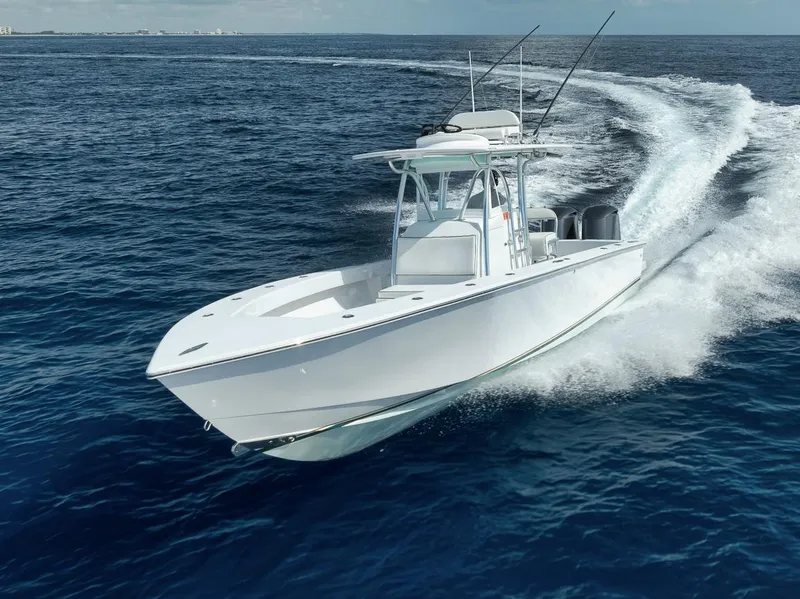 Slide: The Image of 1995 Jupiter 31 Center Console boat cruising on open ocean waters. - 1