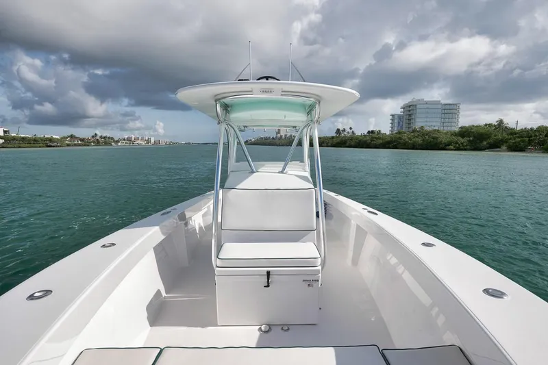 Slide: The Image of 1995 Jupiter 31 Center Console boat on calm water under cloudy sky. - 10