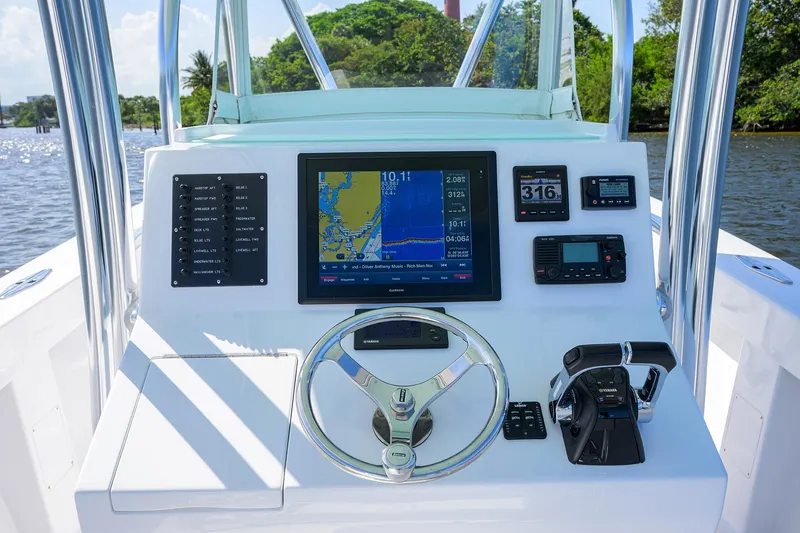 Slide: The Image of Center console of a 1995 Jupiter 31 boat with navigation equipment and steering wheel. - 14