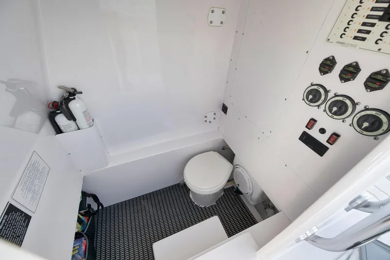 Slide: The Image of Interior of 1995 Jupiter 31 Center Console boat with toilet and control panel. - 16