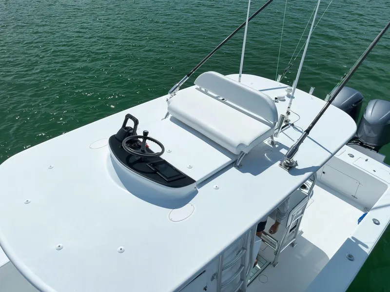 Slide: The Image of 1995 Jupiter 31 Center Console boat on water, featuring a spacious deck and seating area. - 17