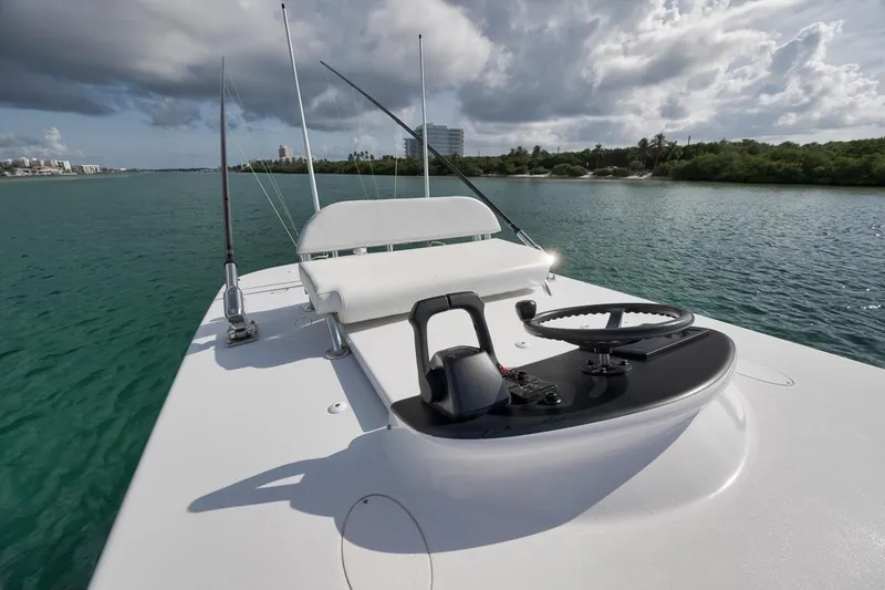Slide: The Image of 1995 Jupiter 31 Center Console boat on calm water under cloudy sky. - 18