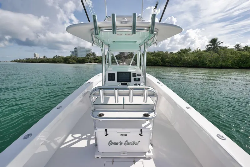 Slide: The Image of 1995 Jupiter 31 Center Console boat on calm water, featuring a sleek design and modern controls. - 21