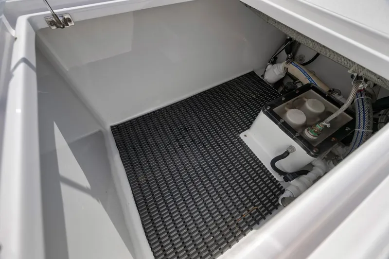 Slide: The Image of Storage compartment of a 1995 Jupiter 31 Center Console boat, featuring a clean interior. - 25