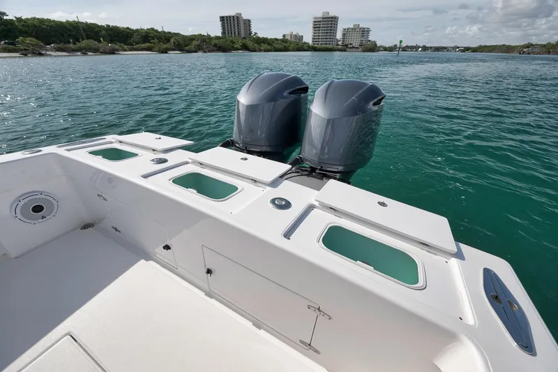 Slide: The Image of 1995 Jupiter 31 Center Console boat with dual outboard motors on calm water. - 27
