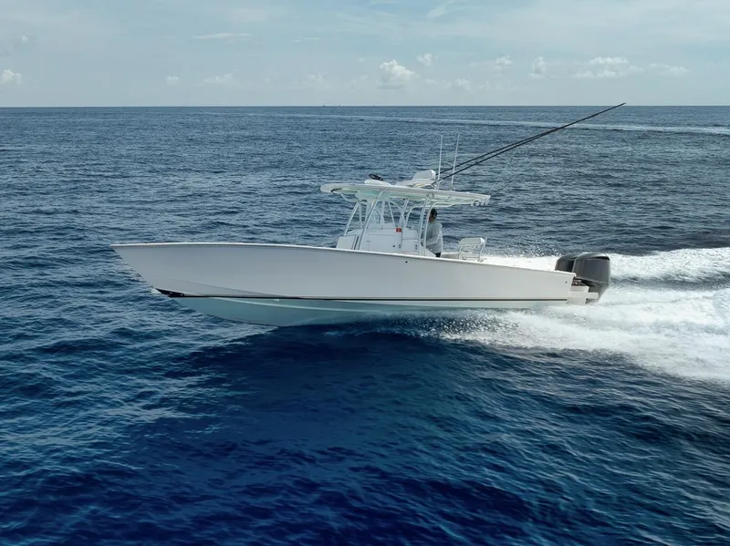 Slide: The Image of 1995 Jupiter 31 Center Console boat cruising on open ocean waters. - 29