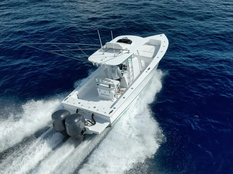 Slide: The Image of 1995 Jupiter 31 Center Console boat cruising on open blue water. - 30