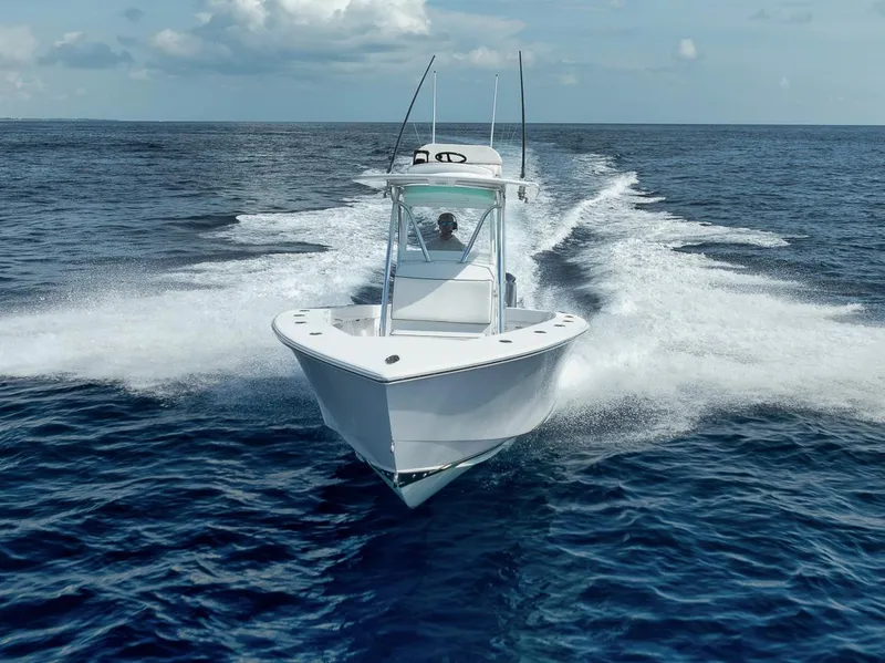 Slide: The Image of 1995 Jupiter 31 Center Console boat cruising on open ocean waters. - 31