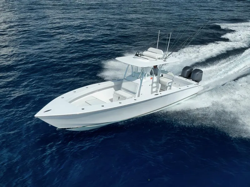 Slide: The Image of 1995 Jupiter 31 Center Console boat cruising on open water. - 32