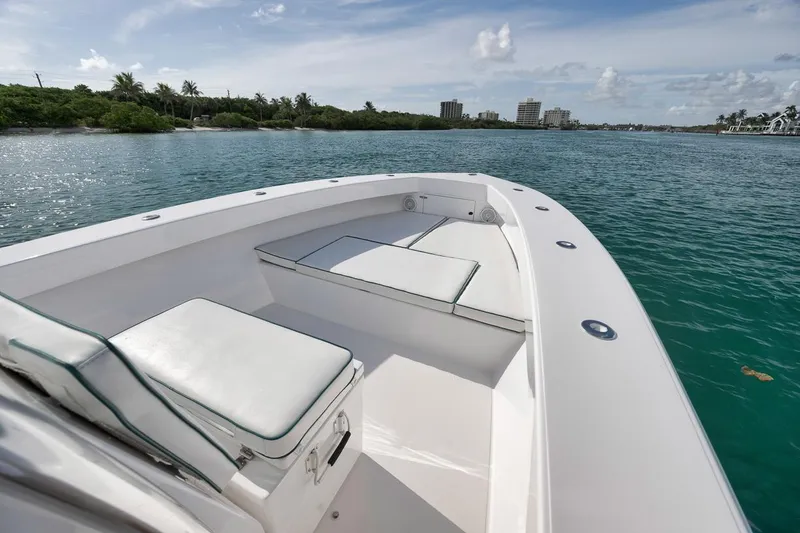 Slide: The Image of 1995 Jupiter 31 Center Console boat on calm water, featuring spacious seating and clear skies. - 4