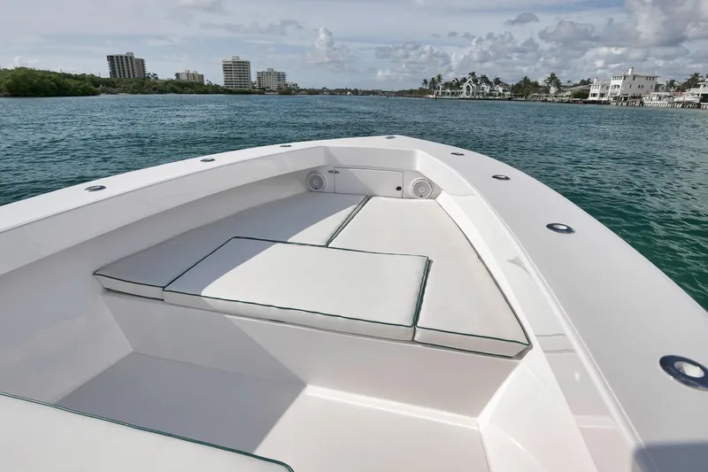 Slide: The Image of 1995 Jupiter 31 Center Console boat on calm water, featuring spacious seating and scenic coastal view. - 5