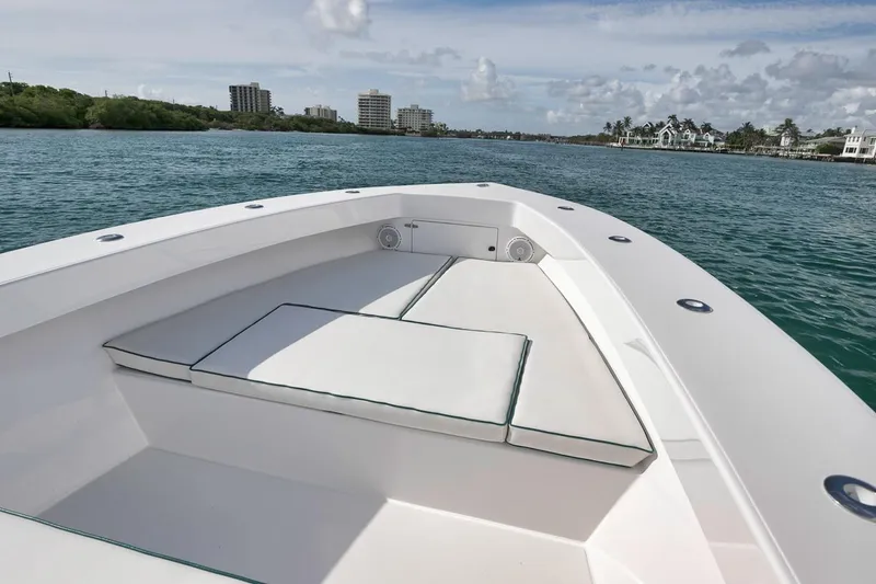 Slide: The Image of 1995 Jupiter 31 Center Console boat on calm water, featuring spacious seating and scenic coastal view. - 6