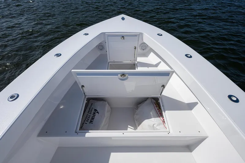 Slide: The Image of 1995 Jupiter 31 Center Console boat with open storage compartments on calm water. - 9