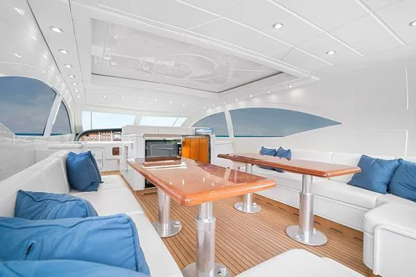 Slide: The Image of Luxurious interior of 2001 Mangusta 72 Open yacht with white seating and blue cushions. - 14