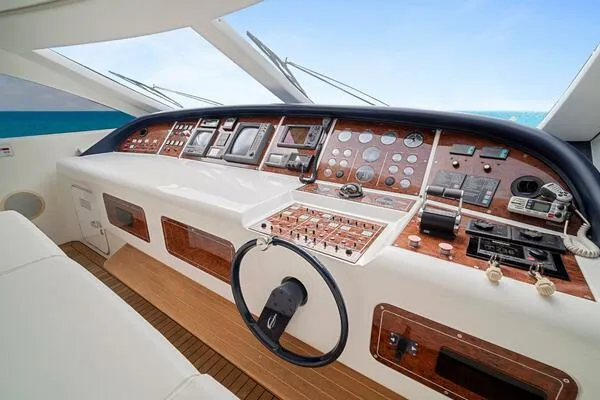 Slide: The Image of Cockpit of 2001 Mangusta 72 Open yacht with modern navigation controls and wooden accents. - 18