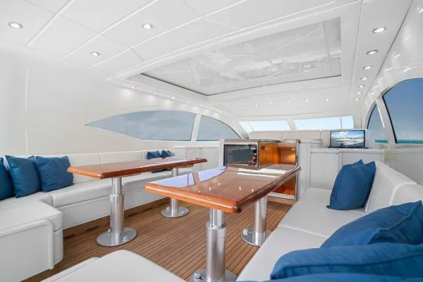 Slide: The Image of Luxurious interior of 2001 Mangusta 72 Open yacht with elegant seating and wooden tables. - 12