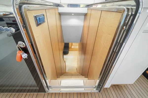 Slide: The Image of Interior staircase of 2001 Mangusta 72 Open yacht with wooden paneling and modern design. - 19