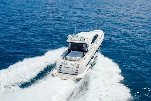 Slide: The Image of Mangusta 72 Open 2001 yacht cruising on open sea, leaving a wake behind. - 2