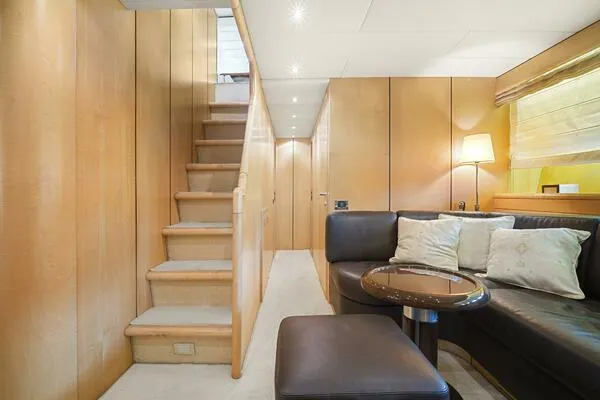 Slide: The Image of Luxurious interior of 2001 Mangusta 72 Open yacht with wooden stairs and cozy seating area. - 20