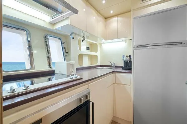 Slide: The Image of Luxurious kitchen interior of 2001 Mangusta 72 Open yacht with modern appliances. - 25