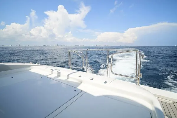Slide: The Image of Mangusta 72 Open yacht cruising on open sea, 2001 model, clear sky, distant city skyline. - 8