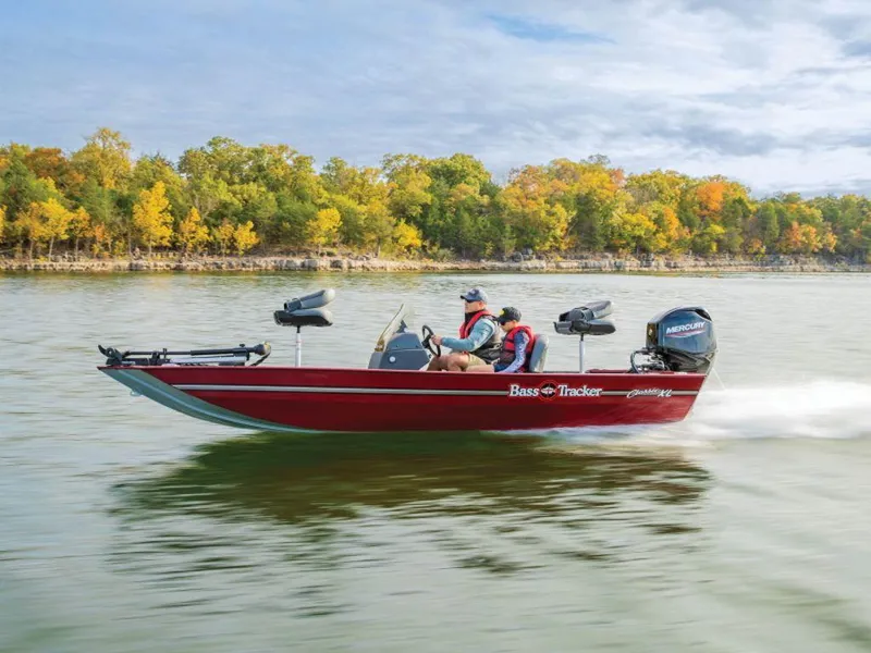 Slide: The Image of 2024 Tracker BASS TRACKER® Classic XL boat cruising on a scenic lake. - 15