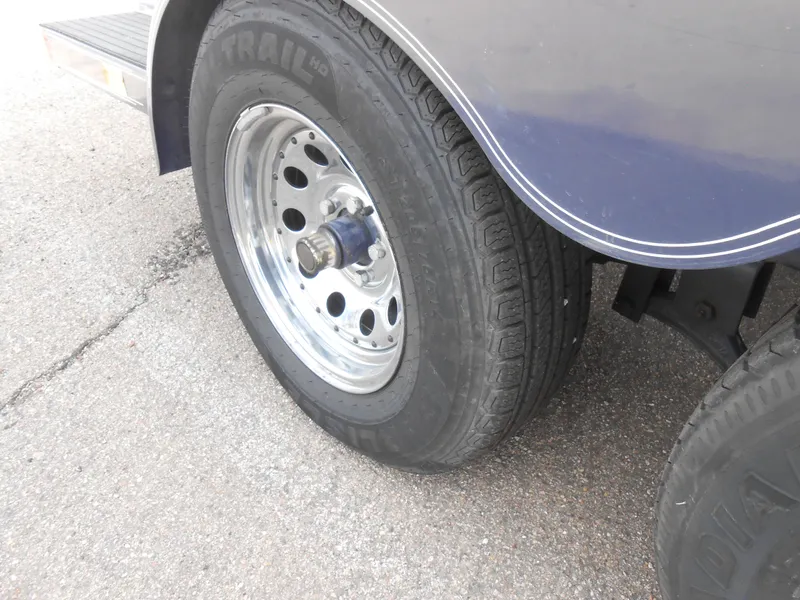 Slide: The Image of Trailer wheel of a 2000 Chris-Craft 200 Bowrider SS on pavement. - 15