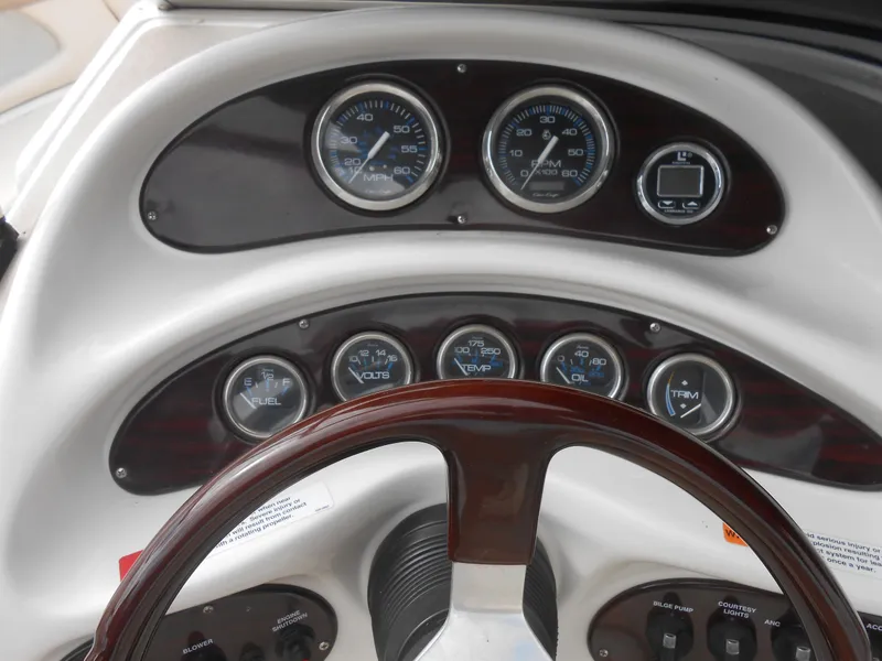 Slide: The Image of Dashboard of 2000 Chris-Craft 200 Bowrider SS with gauges and steering wheel. - 4