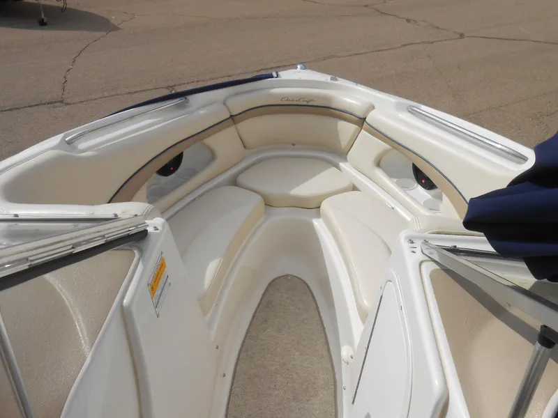 Slide: The Image of 2000 Chris-Craft 200 Bowrider SS interior with white seating and open bow design. - 6