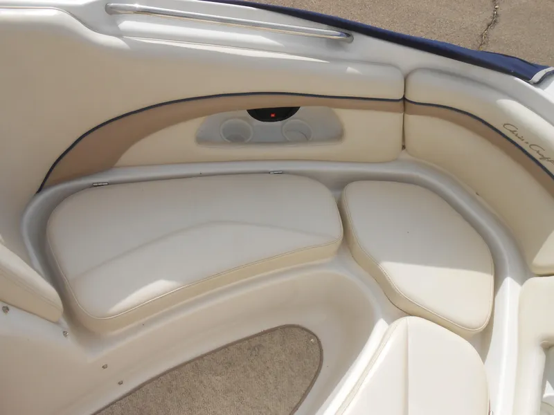 Slide: The Image of 2000 Chris-Craft 200 Bowrider SS interior seating with beige upholstery and speaker system. - 7