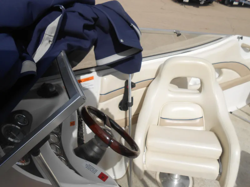 Slide: The Image of 2000 Chris-Craft 200 Bowrider SS interior with steering wheel and seating. - 9