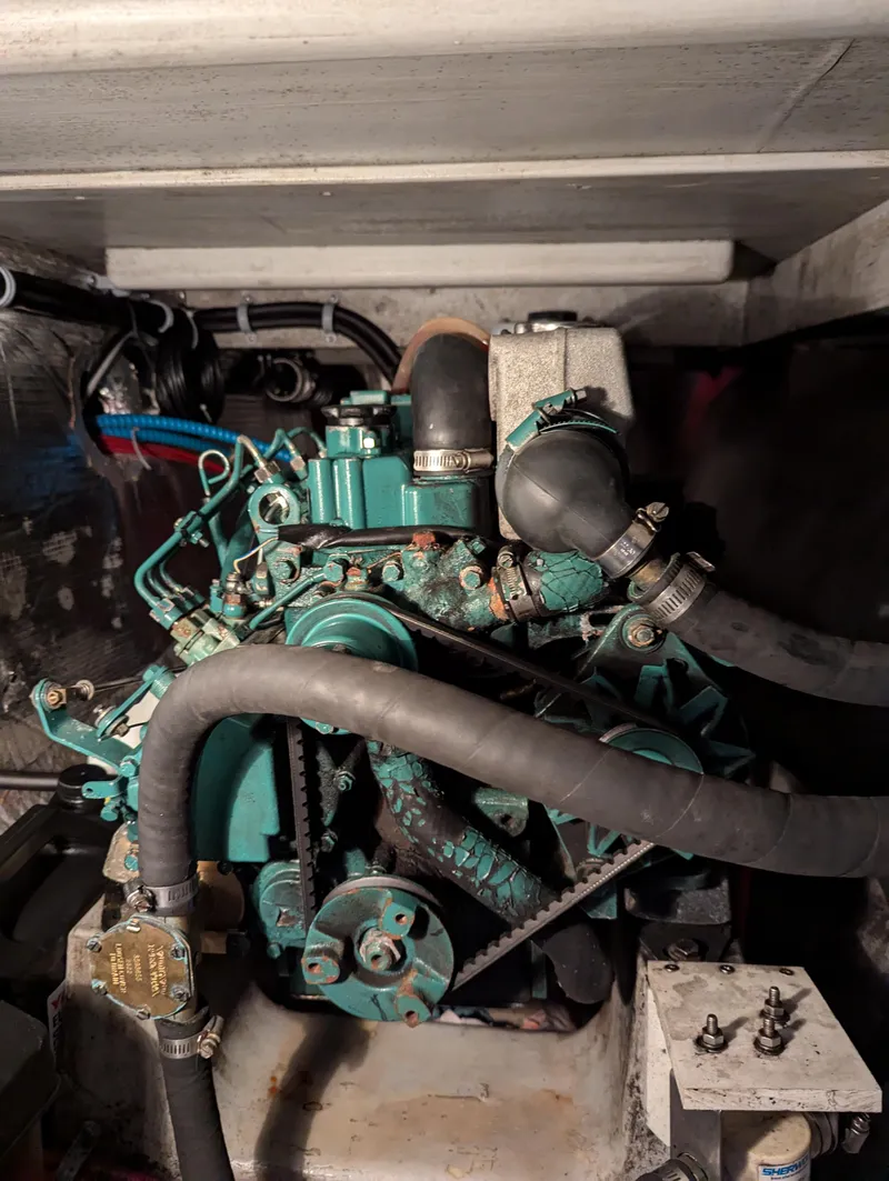 Slide: The Image of Engine compartment of a 2000 Manta 42 sailboat, showcasing mechanical components and hoses. - 18