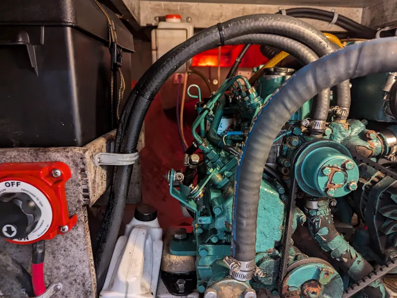 Slide: The Image of Engine compartment of a 2000 Manta 42 sailboat, featuring mechanical components and wiring. - 20