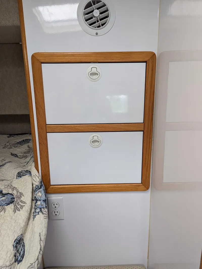 Slide: The Image of Interior of 2000 Manta 42 with wooden-framed storage compartments and a vent. - 24