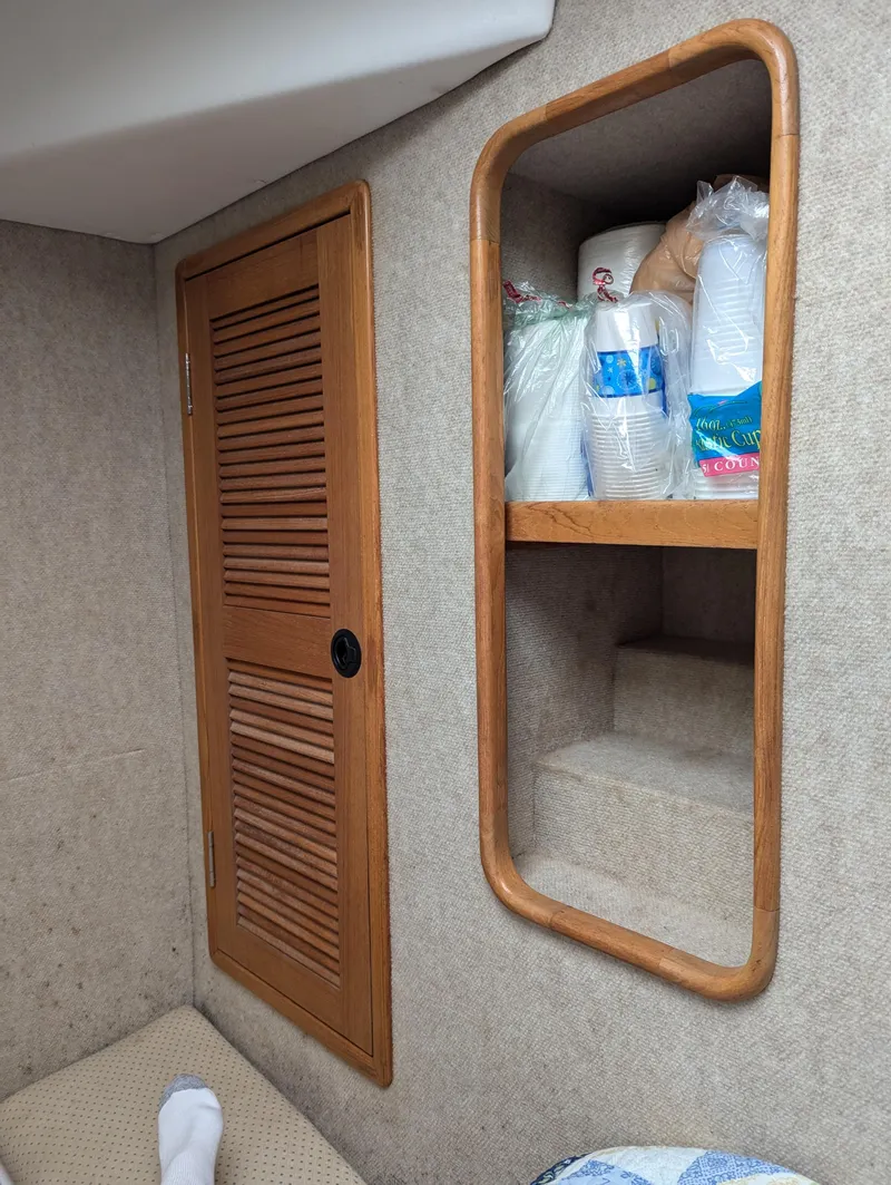 Slide: The Image of Interior of a 2000 Manta 42 boat with wooden cabinet and shelves. - 27