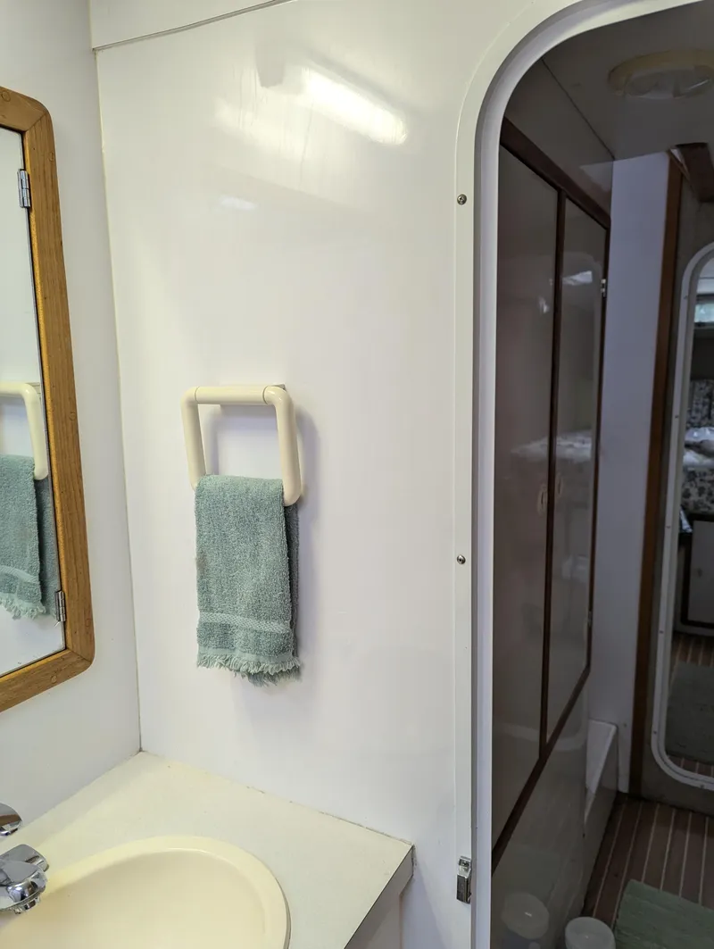 Slide: The Image of Bathroom interior of a 2000 Manta 42 yacht, featuring a sink and towel rack. - 37