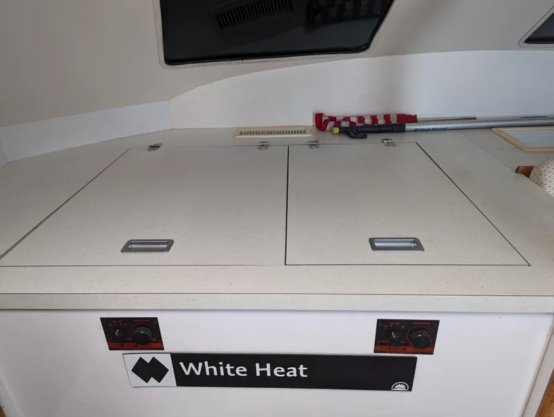 Slide: The Image of Storage compartment on a 2000 Manta 42 catamaran, labeled "White Heat." - 47