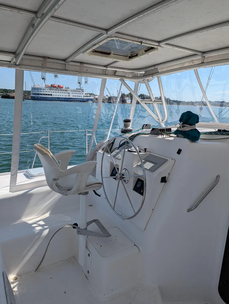 Slide: The Image of Helm of 2000 Manta 42 catamaran with ocean view in background. - 8
