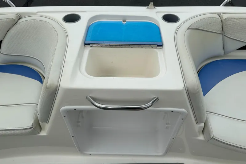 Slide: The Image of 2006 Bayliner 217 boat interior with seating and storage compartment. - 10