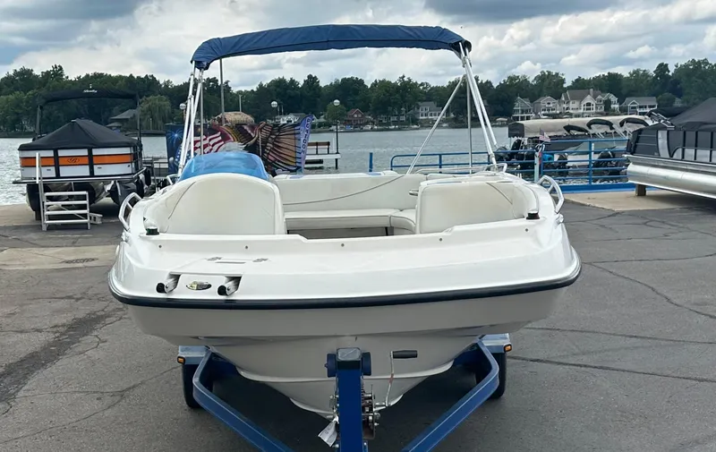 Slide: The Image of 2006 Bayliner 217 boat on trailer by lakeside dock. - 3