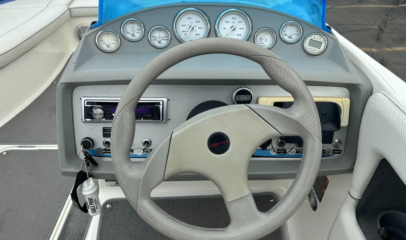 Slide: The Image of 2006 Bayliner 217 boat dashboard with steering wheel and gauges. - 6