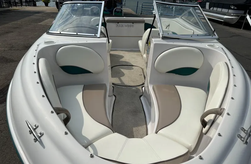 Slide: The Image of 1997 Four Winns Horizon QX boat interior with white seating and open bow design. - 11