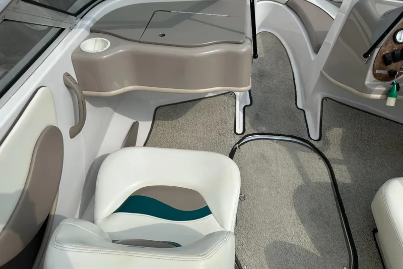 Slide: The Image of Interior of 1997 Four Winns Horizon QX boat with beige and white seating. - 12
