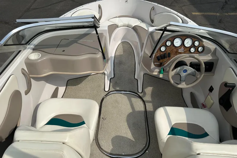 Slide: The Image of Interior of 1997 Four Winns Horizon QX boat with steering wheel and seating. - 13