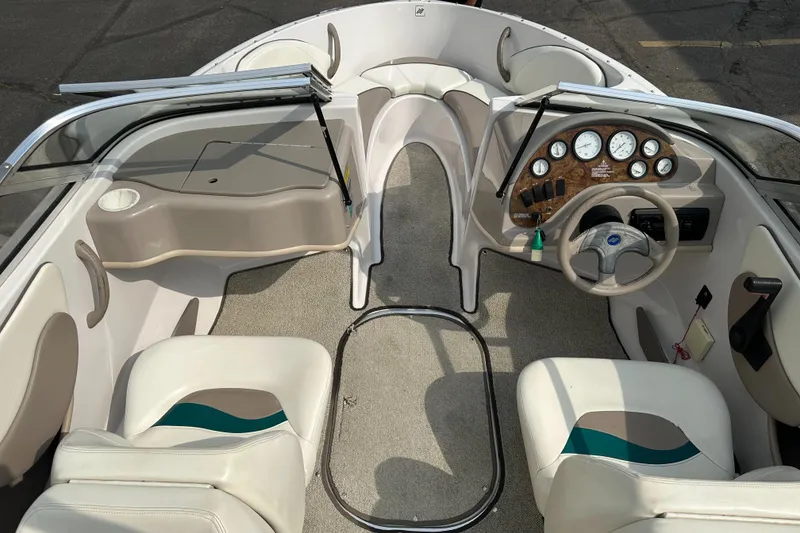 Slide: The Image of 1997 Four Winns Horizon QX boat interior with steering wheel and seating. - 14