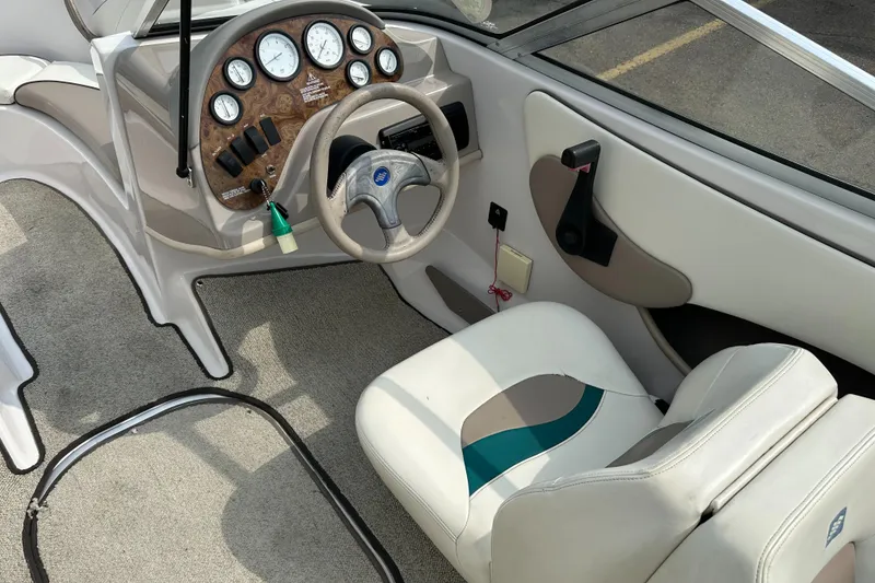 Slide: The Image of 1997 Four Winns Horizon QX boat interior with steering wheel and dashboard controls. - 15