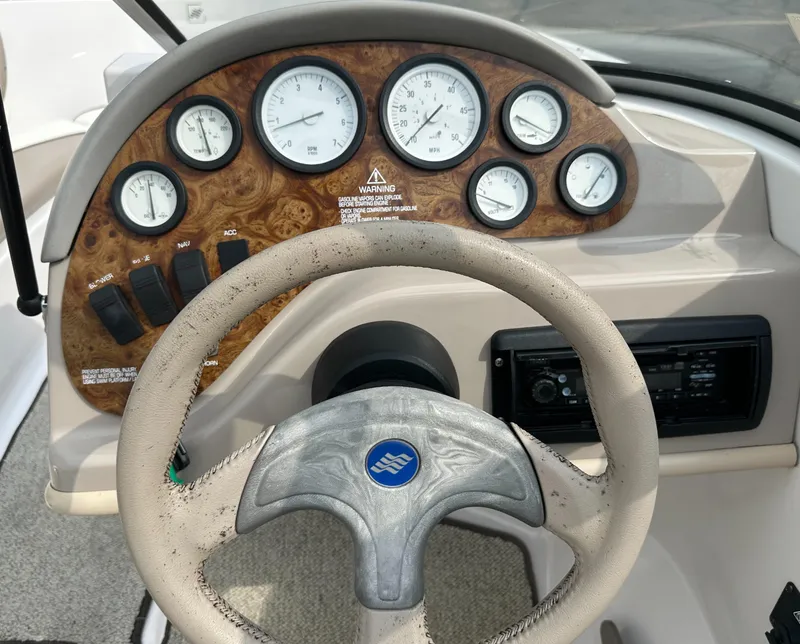 Slide: The Image of Steering wheel and dashboard of 1997 Four Winns Horizon QX boat with gauges. - 16