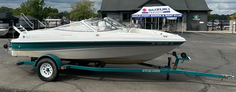Slide: The Image of 1997 Four Winns Horizon QX boat on trailer at marina. - 18