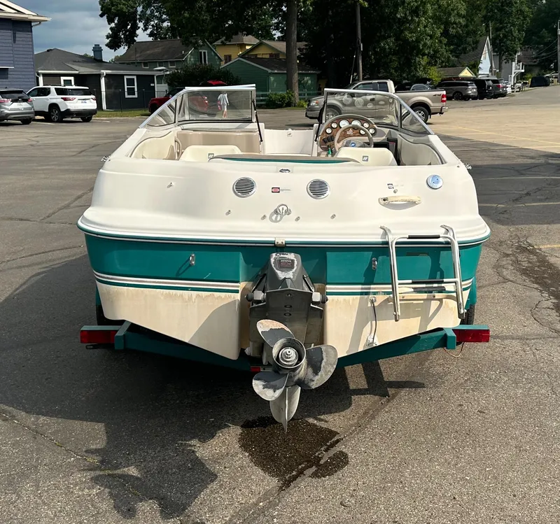 Slide: The Image of 1997 Four Winns Horizon QX boat, rear view, parked on pavement. - 4